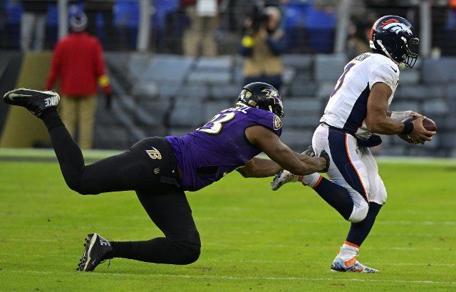 Baltimore Ravens defensive tackle Calais Campbell (93) tackles Denver Broncos quarterback Russell Wilson (3) from behind during the second half at M&T Bank Stadium in Baltimore, Maryland, on Sunday, December 4, 2022. Baltimore won 10-9. Photo by David Tulis