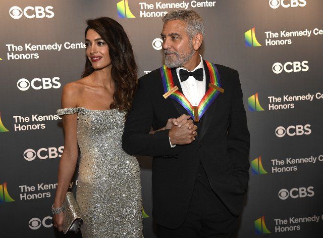 2022 Kennedy Center Honoree actor George Clooney holds hands with his wife Amal as they arrive for a gala evening in Washington, Sunday, December 4, 2022. The Honors are awarded for a lifetime achievement in the arts and culture. Photo by Mike Theiler