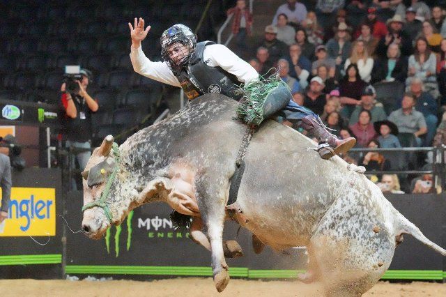 Professional Bull Rider Dalton Kasel tries to hang onto his bull \