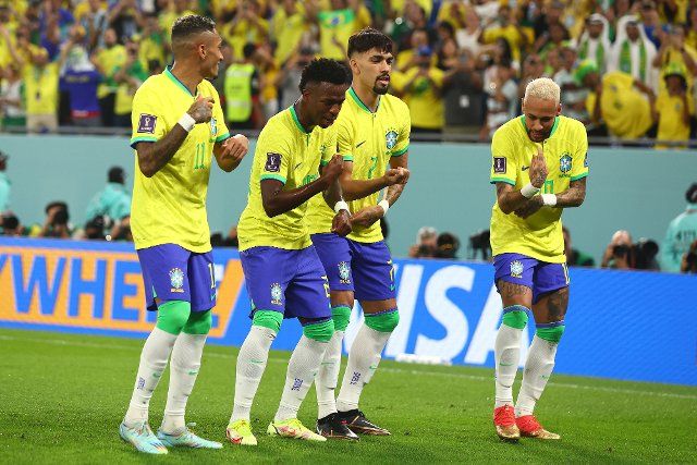 Vinicius Jr of Brazil celebrates scoring the opening goal with his team-mates during the 2022 FIFA World Cup Round of 16 match at Stadium 974 in Doha, Qatar on December 05, 2022. Photo by Chris Brunskill