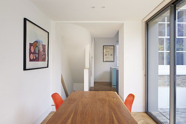 Dining space with sliding door to garden. Queens House, London, United Kingdom. Architect: Paul Archer Design - Architects & Design, 2021
