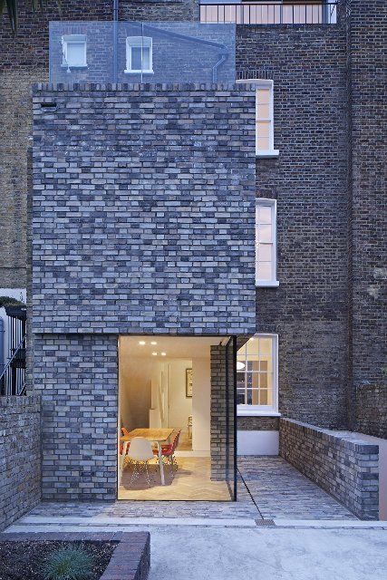 Extension view at dusk with lit interiors. Queens House, London, United Kingdom. Architect: Paul Archer Design - Architects & Design, 2021