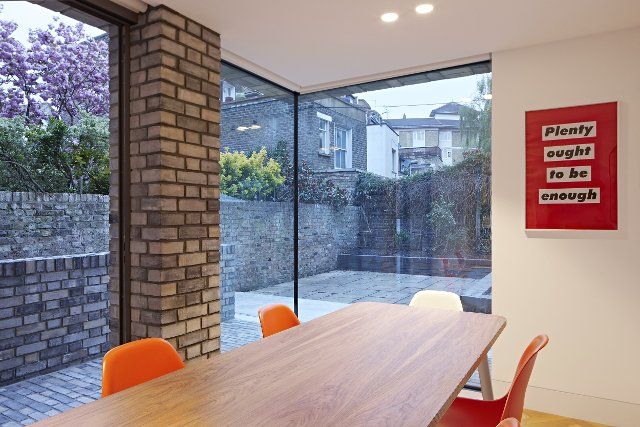 Dining space with corner glazing. Queens House, London, United Kingdom. Architect: Paul Archer Design - Architects & Design, 2021