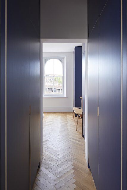 Corridor to bedroom with parquet. Queens House, London, United Kingdom. Architect: Paul Archer Design - Architects & Design, 2021