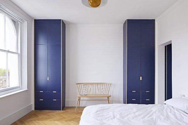 Bedroom with built-in storage cupboards. Queens House, London, United Kingdom. Architect: Paul Archer Design - Architects & Design, 2021