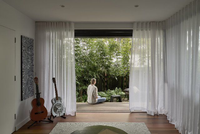 Music room looking out to deck and garden. Birchgrove House, Sydney, Australia. Architect: TW Architects, 2021