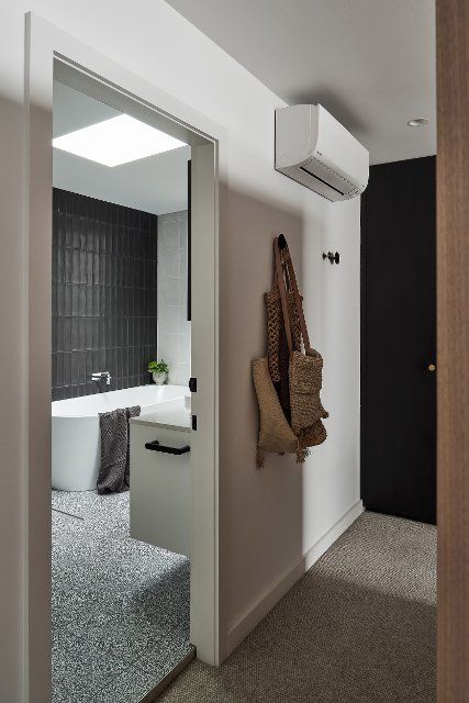 Walk-in wardrobe and ensuite within master bedroom. Birchgrove House, Sydney, Australia. Architect: TW Architects, 2021