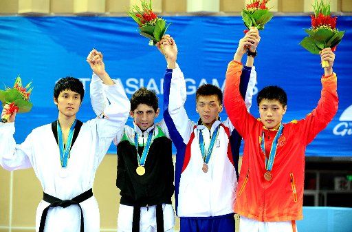 (101119) -- GUANGZHOU Nov. 19 2010 (Xinhua) -- Gold medalist Mohammad Bagheri Motamed (2nd L)of Iran greets the spectators with silver medalist Jang Se Wook(1st L) of South Korea and bronze medalists Lo Tsung Jui (2nd R) of Chinese Taipei and ...