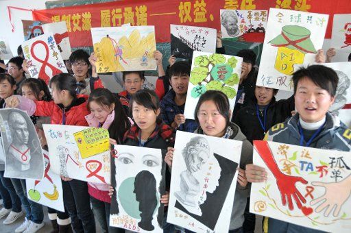 (101129) -- CHAOHU Nov. 29 2010 (Xinhua) -- Students of the Hanshan County Vocational Education Center display their self-designed anti-HIV\/AIDS posters in an HIV and AIDS prevention campaign in the Hanshan County east China\