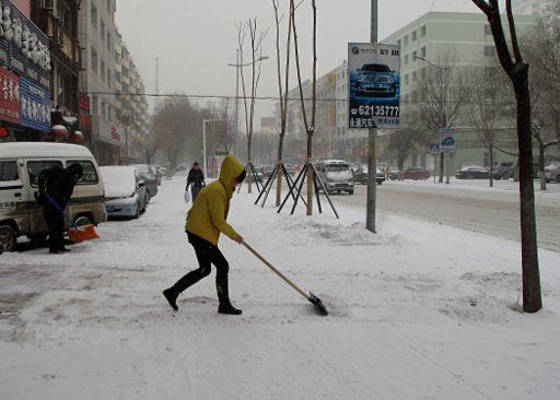 (101202) -- JILIN Dec. 2 2010 (Xinhua) -- A woman shovels snow in Jilin northeast China\