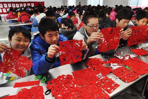 (101228) -- BINZHOU Dec. 28 2010 (Xinhua) -- Students show their paper cutting works at a middle school in Zouping County east China\