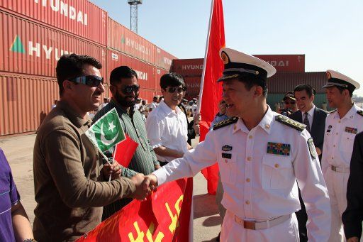 (110313) -- KARACHI March 13 2011 (Xinhua) -- Huang Xiaohu (R front) commander of 8th escort flotilla sent by the Chinese Navy shakes hands with a Pakistani man during the farewell ceremony in Karachi Pakistan March 13 2011. The flotilla ...