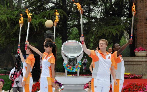 (110425) -- BEIJING April 25 2011 (Xinhua) -- Representatives from five continents demonstrate the flame at the Tsinghua University in Beijing capital of China April 25 2011. The World University Games flame was kindled on Monday in Beijing. ...