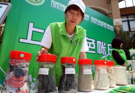 (110515) -- SHANGHAI May 15 2011 (Xinhua) -- Volunteers show environmental friendly materials in a community of Shanghai east China May 15 2011. A garbage classification system will cover more than 1000 communities of the city till the end of ...