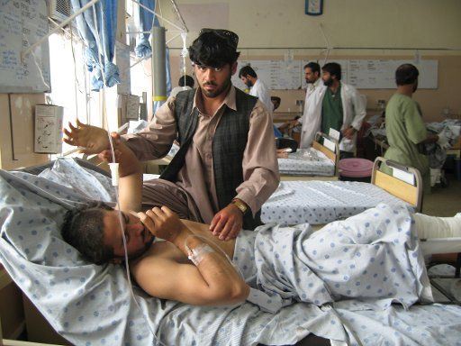 (110524) -- KANDAHAR May 24 2011 (Xinhua) -- An injured Afghan man receives medical treatment after a roadside bomb in Panjwayi District of Kandahar City southern Afghanistan on May 24 2011. Ten people were killed and 28 others injured when a ...