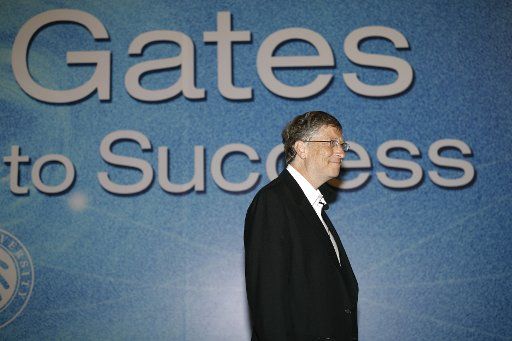 (110611) -- BEIJING June 11 2011 (Xinhua) -- Microsoft founder and co-chair of the Bill and Melinda Gates Foundation (BMGF) Bill Gates walks past a poster with his name during an interactive forum with the students at Peking University on the ...
