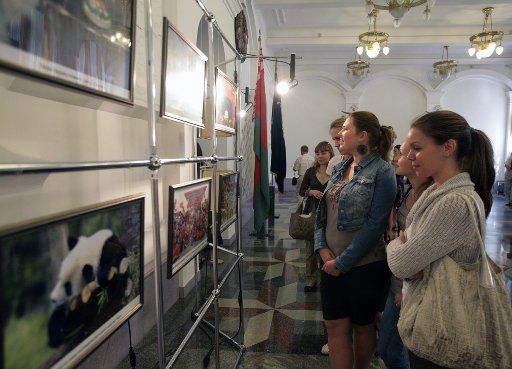 (110614) -- MINSK June 14 2011 (Xinhua) -- Visitors view the photos at the "Xinhua Gallery" photo exhibition at Belarusian State University in Minsk Belarus June 14 2011. The "Xinhua Gallery" photo exhibition jointly launched by Xinhua News ...