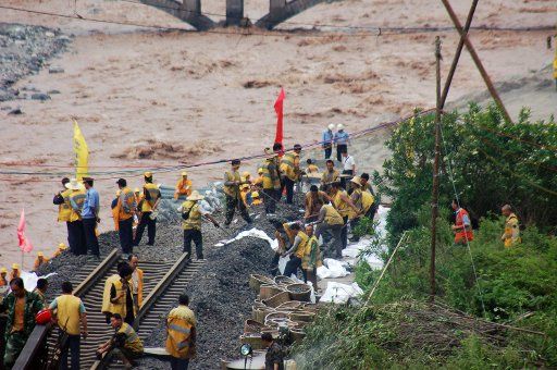 (110620) -- CHENGDU June 20 2011 (Xinhua) -- Workers repave the railway buried and damaged by rain-triggered landslides on the Baiguo-Baishiyan scetion of the Chengdu-Kunming railway southwest China June 19 2011. The Chengdu-Kunming railway ...