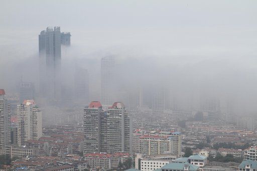 (110601) -- YANTAI June 1 2011 (Xinhua) -- Photo taken on June 1 2011 shows buildings shrouded in heavy smog in the coastal city of Yantai east China\