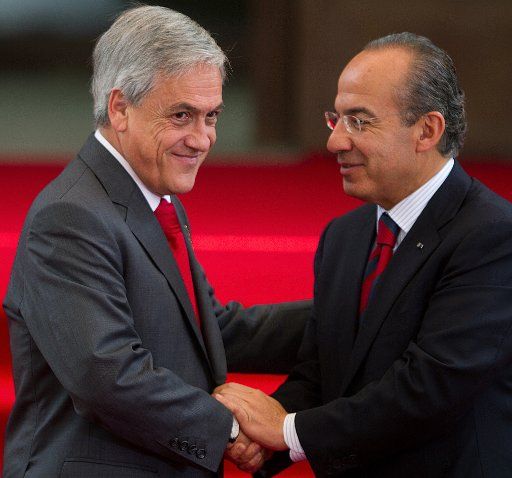 (110709) -- MEXICO CITY July 9 2011 (Xinhua) -- Chilean President Sebastian Pinera (L) shakes hands with his Mexican counterpart Felipe Calderon after the conclusion of agreements between both countries at the presidential residence Los Pinos in ...