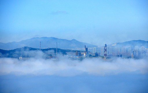 (110714) -- DALIAN July 14 2011 (Xinhua) -- Photo taken on July 14 2011 shows the advection fog surrounding buildings in the Donggang harbor in Dalian City northeast China\