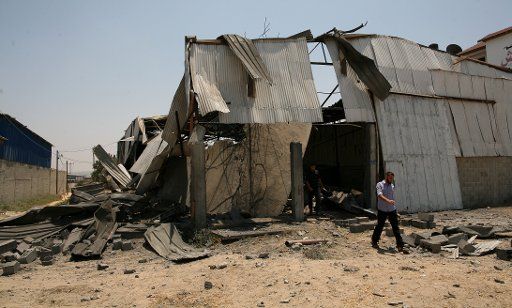 (110714) -- GAZA July 14 2011 (Xinhua) -- A Palestinian man inspects a destroyed warehouse after an Israeli air raid in Gaza Strip on July 14 2011. Israeli airplanes carried out two airstrikes in the Gaza Strip around midnight witnesses said ...