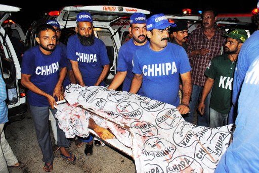 (110627) -- KARACHI June 27 2011 (Xinhua) -- Rescuers transfer an injured man to a hospital in southern Pakistani port city of Karachi on June 27 2011. At least seven people were injured in three hand grenade blasts at a hotel in the downtown ...