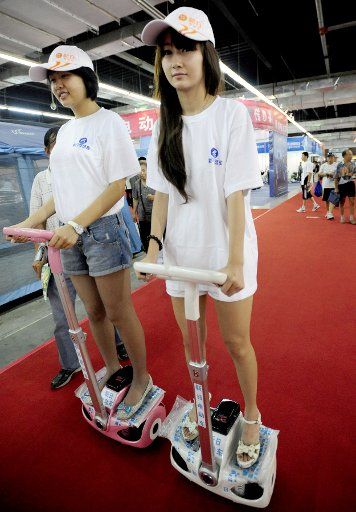 (110813) -- SHENYANG Aug. 13 2011 (Xinhua) -- Staff members present new electric bicycles on a bicycle exhibition in Shenyang northeast China\