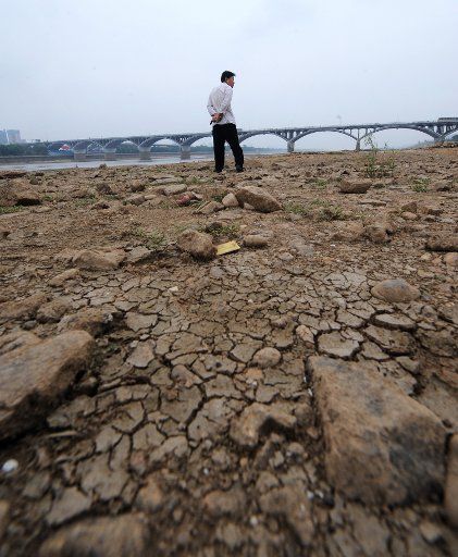 (110909) -- CHANGSHA Sept. 9 2011 (Xinhua) -- Photo taken on Sept. 9 2011 shows a local citizen walking on the riverbed of the Xiangjiang River in Changsha section central China\