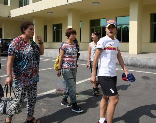 (110826) -- HARBIN Aug. 26 2011 (Xinhua) -- Wang Meng (1st R) leaves the training hall as her mother Zhang Xiaoxia (1st L) follows after a training session of the team of Heilongjiang province in Harbin capital of northeast China\