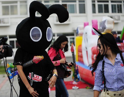 (110918) -- BEIJING Sept. 18 2011 (Xinhua) -- The mascot interacts with a music fan at the Black Rabbit Music Festival held in the Chaoyang Sports Center in Beijing capital of China Sept. 17 2011. The next stage of the music festival will be ...
