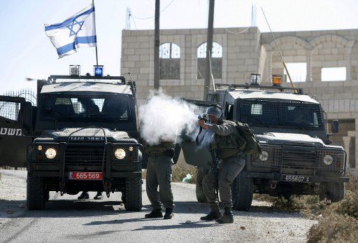 (110920)-- WEST BANK Sept. 20 2011 (Xinhua) -- Israeli soldiers fire tear-gas canisters at Palestinian protesters during clashes in the West Bank village of Assira near Nablus on Sept. 20 2011. Two Palestinians were injured in clashes between ...
