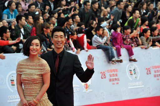 (111022) -- HEFEI Oct. 22 2011 (Xinhua) -- Actor Wang Qianyuan and actress Qin Hailu pose on the red carpet for the closing ceremony of the 20th China Golden Rooster and Hundred Flowers Film Festival at Hefei east China\