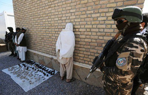 (111013) -- HERAT Oct. 13 2011 (Xinhua) -- Three terrorists stand with their explosive device after captured by Afghan security force in Herat Afghanistan Oct. 13 2011. Afghan security force have captured three terrorists during their ...