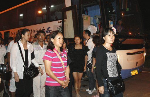 (111014) -- XISHUANGBANNA Oct. 14 2011 (Xinhua) -- Family members of the Chinese sailors killed or missing in the attack on two cargo ships on Mekong River earlier this month arrive at Mohan Port in southwest China\