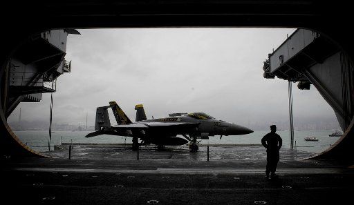 (111109) -- HONG KONG Nov. 9 2011 (Xinhua) -- A U.S. naval soldier stands next to a fighter plane on board U.S. aircraft carrier USS George Washington in Hong Kong south China Nov. 9 2011. The U.S. nuclear powered aircraft carrier USS George ...