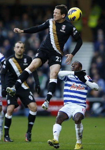 (121216) -- LONDON, Dec. 16, 2012 (Xinhua) -- Sascha Riether (above) of Fulham vies with Shaun Wright-Phillips of Queens Park Rangers during the Barclays Premier League match at Loftus Road in London, Britain, on Dec. 15, 2012. QPR won 2-1. (Xinhua\/...