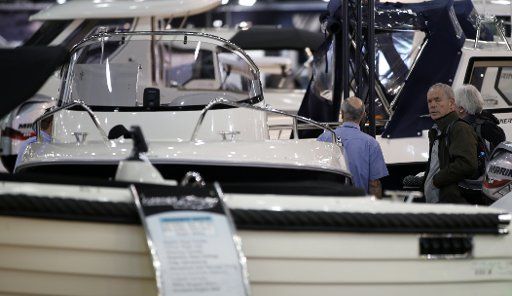 (130114) -- LONDON, Jan. 14, 2013 (Xinhua) -- Visitors view yachts on display at the 58th London Boat Show, held at the ExCeL Exhibition and Convention Centre in London, Jan. 14, 2013. The 58th London Boat Show showcases, demonstrates and sells ...