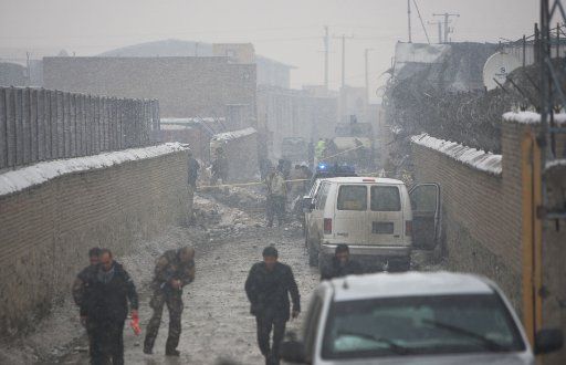 (121217) -- KABUL, Dec. 17, 2012 (Xinhua) -- Afghan security officers inspect the site of suicide car bombing in Kabul, Afghanistan on December 17, 2012. At least two people were killed and 15 others wounded Monday morning when a suicide car bomb ...