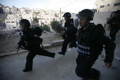 (121219) -- JERUSALEM, Dec. 19, 2012 (Xinhua) -- Israeli soldiers react during clashes with Palestinian protestors in the neighbourhood of Issawiya near Jerusalem on Dec. 19, 2012. Palestinians Wednesday demonstrated in solidarity with Samer Issawi, ...