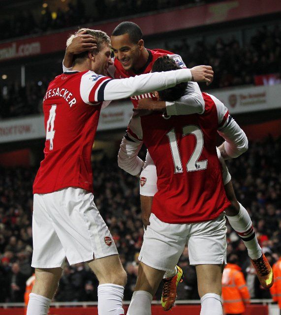 (130124) -- LONDON, Jan. 24, 2013 (Xinhua) -- Oliver Giroud (R) of Arsenal celebrates his first goal with teammates Theo Walcott (Top) and Per Mertesacker during the English Premier League football match between Arsenal and West Ham United at the ...
