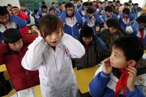 (130301) -- MAANSHAN, March 1, 2013 (Xinhua) -- Students do ear exercises during an activity celebrating the upcoming Ear-care Day, which falls on March 3 every year, at a primary school in Maanshan City, east China\
