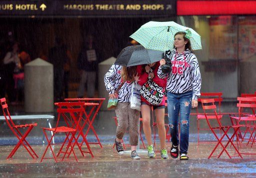 (130523) -- NEW YORK, May 23, 2013 (Xinhua) -- A person walks in rain at the Times Square in midtown Manhattan, May 23, 2013. In its 2013 Atlantic hurricane season outlook issued today, the US National Oceanic and Atmospheric administration (NOAA) ...