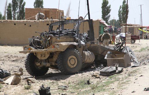 (130625) -- GHAZNI, June 25, 2013 (Xinhua) -- Polish soldiers with the NATO-led International Security Assistance Force (ISAF) stand near an armored vehicle that was hit by a roadside bomb in Ghazni province in eastern of Afghanistan, on June 25, ...