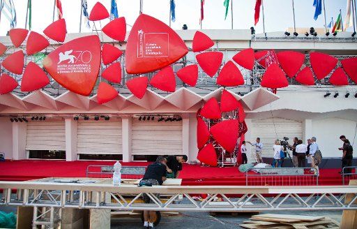 (130827) -- VENICE, Aug. 27, 2013 (Xinhua) -- Employees works at red carpet of the Venice International Film Festival in Venice, Italy, Aug. 27, 2013. The 70th edition of the Venice International Film Festival is expected to start on Aug. 28 on the ...