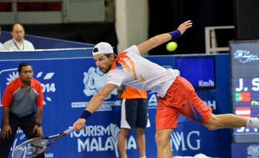 (130928) -- KUALA LUMPUR, Sept. 28, 2013 (Xinhua) -- Jurgen Melzer of Austria hits a return during the match against Joao Sousa of Portugal at the 2013 Malaysia Open Tennis in Kuala Lumpur, Malaysia, on Sept. 28, 2013. Sousa won the match 2-1 to ...