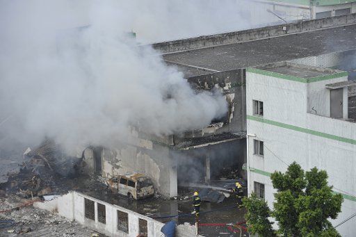 (130910) -- GUANGZHOU, Sep. 10, 2013 (Xinhua) -- Firefighters put out a fire after an explosion occurred in a roadside storehouse in Guangzhou, capital of south China\