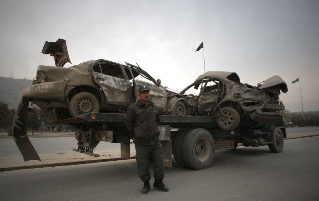 (131116) -- KABUL, Nov. 16, 2013 (Xinhua) -- An Afghan policeman stands guard beside destroyed vehicles on a truck at the site of a suicide car bombing in Kabul, Afghanistan, on November 16, 2013. A powerful blast rocked Afghan capital Kabul on ...