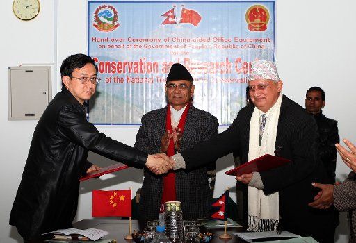 (140109) -- KATHMANDU, Jan. 9, 2014 (Xinhua) -- Chinese Ambassador to Nepal Wu Chuntai (L) shakes hands with Govinda Gajurel, secretary general of the Research Center of Nepal National Trust for Nature Conservation, after the signing of "Delivery ...