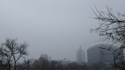 (140201) -- Beijing, Feb. 1, 2014 (Xinhua) -- Photo taken on Feb. 1, 2014 shows buildings shrouded by dense fog near Xuanwumen in Beijing, capital of China. Beijing witnessed heavy fog on Saturday, the second day of a seven-day break for the Chinese ...